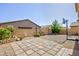 Spacious backyard featuring a gravel area, a paved patio, and a basketball hoop for outdoor recreation at 210 Red Sandstone Ave, North Las Vegas, NV 89031