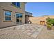 Backyard featuring a stone patio, low-maintenance gravel landscaping, and a built-in outdoor grill area at 210 Red Sandstone Ave, North Las Vegas, NV 89031
