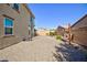 The backyard provides ample space with gravel landscaping, stone patio, and lush greenery for outdoor enjoyment at 210 Red Sandstone Ave, North Las Vegas, NV 89031