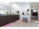 Bathroom featuring double sink vanity, and pink rugs with a separate makeup vanity at 210 Red Sandstone Ave, North Las Vegas, NV 89031