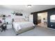 Bright bedroom featuring accent wall, desk, carpet flooring and natural light at 210 Red Sandstone Ave, North Las Vegas, NV 89031