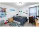 A cozy bedroom with gray carpet, a bed with blue covers, and space for a desk at 210 Red Sandstone Ave, North Las Vegas, NV 89031