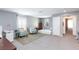 Spacious bedroom with neutral walls features two chairs, a daybed, and access to another room for versatile use at 210 Red Sandstone Ave, North Las Vegas, NV 89031