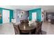 Open-concept dining area featuring a large dining table with seating for eight and tile flooring at 210 Red Sandstone Ave, North Las Vegas, NV 89031