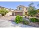 Charming two-story home featuring a two-car garage and a well-maintained front yard with green bushes at 210 Red Sandstone Ave, North Las Vegas, NV 89031