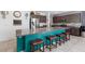 Close up of a large kitchen island with granite countertop and bar stool seating at 210 Red Sandstone Ave, North Las Vegas, NV 89031