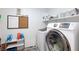 Laundry area featuring a washer and dryer, shelving with supplies, and white walls at 210 Red Sandstone Ave, North Las Vegas, NV 89031