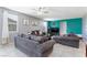 Comfortable living room featuring plush sofas, a ceiling fan, and natural light at 210 Red Sandstone Ave, North Las Vegas, NV 89031