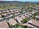 Wide aerial view of single-story home in an established community with lush landscaping and a golf course nearby at 2118 High Mesa Dr, Henderson, NV 89012