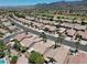 Panoramic aerial view of a residential area with lush trees, green space, and golf course at 2118 High Mesa Dr, Henderson, NV 89012