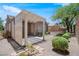 The backyard features desert landscaping, a covered patio, a small lawn, and mature shade trees at 2118 High Mesa Dr, Henderson, NV 89012