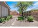 An inviting backyard space with desert landscaping, a small lawn and a stone walking path at 2118 High Mesa Dr, Henderson, NV 89012