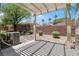 Relaxing backyard with a covered patio, rock wall, and a peaceful setting at 2118 High Mesa Dr, Henderson, NV 89012