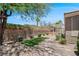 The backyard has a quaint lawn, mature trees, and desert landscaping for low maintenance at 2118 High Mesa Dr, Henderson, NV 89012