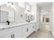 Bright bathroom boasts dual sinks, modern fixtures, marble counters, and neutral walls at 2118 High Mesa Dr, Henderson, NV 89012