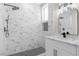 Luxurious bathroom showcasing a new shower with a rainfall showerhead, marble tile, and black hardware at 2118 High Mesa Dr, Henderson, NV 89012
