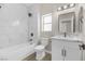Bathroom with a tub, marble tile, vanity, and new fixtures at 2118 High Mesa Dr, Henderson, NV 89012
