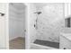 Walk-in shower with rainfall shower head, marble tile, and a bench seat with built-in shelving at 2118 High Mesa Dr, Henderson, NV 89012