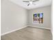 Bright bedroom with new flooring, ceiling fan, and a large window providing a view of the street at 2118 High Mesa Dr, Henderson, NV 89012