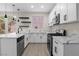 Modern kitchen featuring white cabinets, marble countertops, and stainless steel appliances at 2118 High Mesa Dr, Henderson, NV 89012