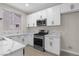 Bright kitchen with white cabinets, stainless steel appliances, and marble countertops at 2118 High Mesa Dr, Henderson, NV 89012