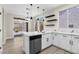 Contemporary kitchen with island, stainless steel appliances, and access to outdoor patio at 2118 High Mesa Dr, Henderson, NV 89012