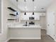 Stylish kitchen with white cabinets, marble countertops, and modern pendant lighting at 2118 High Mesa Dr, Henderson, NV 89012