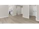 Open living space with neutral walls, wood-look floors, and views of the kitchen at 2118 High Mesa Dr, Henderson, NV 89012