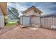 Gravel backyard area with detached shed, decorative sheep statue, and mature trees at 224 Catalini St, Las Vegas, NV 89107