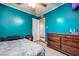 Bedroom showcasing a wooden dresser, vibrant walls, and a ceiling fan at 224 Catalini St, Las Vegas, NV 89107