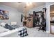 Bedroom with neutral walls, tiled flooring, with a closet and desk with decor at 224 Catalini St, Las Vegas, NV 89107