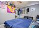 A cozy bedroom with a Lakers theme, ceiling fan, and comfortable bedding at 224 Catalini St, Las Vegas, NV 89107
