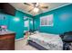 Vibrant bedroom featuring teal walls, ceiling fan, and closet with mirrored doors at 224 Catalini St, Las Vegas, NV 89107