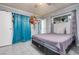Bedroom with grey walls, tiled flooring, a closet and window with neutral colored curtains at 224 Catalini St, Las Vegas, NV 89107