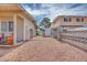 Gravel driveway between properties, leads to a backyard shed at 224 Catalini St, Las Vegas, NV 89107