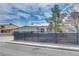 Home exterior with desert landscaping, horizontal siding, and black metal fence at 224 Catalini St, Las Vegas, NV 89107