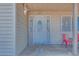 Protected front door with ornate metal security door, covered porch, and tan siding at 224 Catalini St, Las Vegas, NV 89107