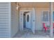 Protected front door with open ornate metal security door, covered porch, and tan siding at 224 Catalini St, Las Vegas, NV 89107