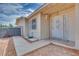 Protected front door with ornate metal security door and tan horizontal siding at 224 Catalini St, Las Vegas, NV 89107