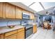 Galley-style kitchen with stainless steel appliances and view to the dining area at 224 Catalini St, Las Vegas, NV 89107