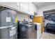 Laundry room featuring storage cabinets and large capacity washer and dryer units at 224 Catalini St, Las Vegas, NV 89107