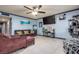 Living room with neutral tile, blue-gray accent walls, and ceiling fan at 224 Catalini St, Las Vegas, NV 89107