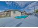 Backyard pool area with lounge chairs, light blue pool, and light blue painted concrete at 224 Catalini St, Las Vegas, NV 89107