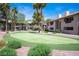 Exterior view of condo putting green and landscaping. Buildings have desert tones and balconies at 2606 S Durango Dr # 142, Las Vegas, NV 89117