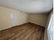 Bright bedroom with hardwood floors and neutral paint, creating a warm and inviting space at 2655 Aracatuba Ave, Las Vegas, NV 89121