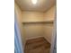 A functional walk-in closet with rod, shelf, and wood flooring for efficient storage and organization at 2655 Aracatuba Ave, Las Vegas, NV 89121