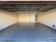 Spacious two car garage with a clean epoxy floor and a white door at 2655 Aracatuba Ave, Las Vegas, NV 89121