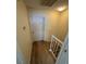 Hallway with wood floors features a light fixture and white doors at 2655 Aracatuba Ave, Las Vegas, NV 89121