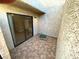 Tiled outdoor patio featuring a textured wall and sliding glass door at 2655 Aracatuba Ave, Las Vegas, NV 89121