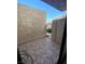 Tiled outdoor patio with a dark metal gate and textured walls at 2655 Aracatuba Ave, Las Vegas, NV 89121